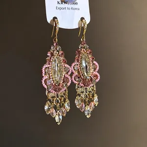 Elegant vintage ethnic rhinestone tassel drop earrings with pink crystals and gold finish