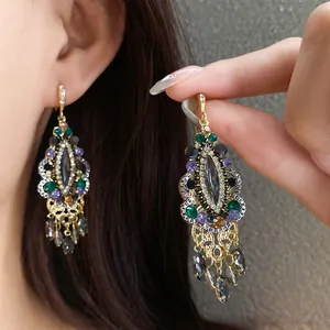 Detailed macro shot of vintage ethnic teardrop tassel earrings with colorful rhinestones