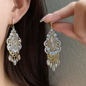 Close-up of vintage ethnic rhinestone tassel earrings with water drop crystals