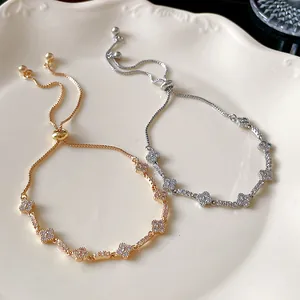 Close-up of elegant Korean style adjustable zircon clover bracelets in gold and silver