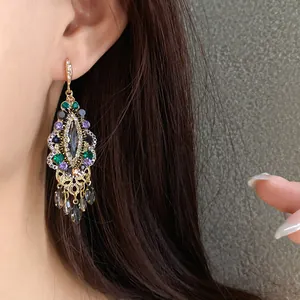 Close-up of vintage ethnic style tassel earrings with colorful rhinestone detail