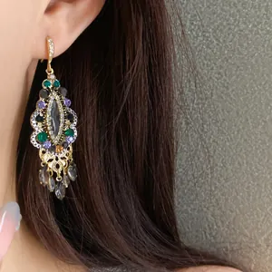 Vintage ethnic gold-tone drop earrings featuring vibrant multi-colored crystals and tassels