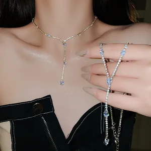 Close-up view of a sparkling teardrop zircon tassel necklace worn by a female model