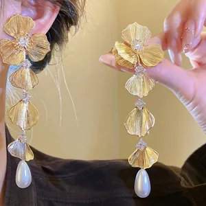 Elegant 18K gold plated flower dangle earrings with teardrop pearls and cubic zirconia.