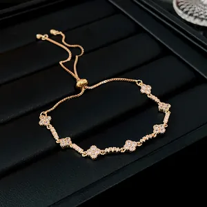 Close-up of zircon flower adjustable bracelet with shimmering gold finish and stones.