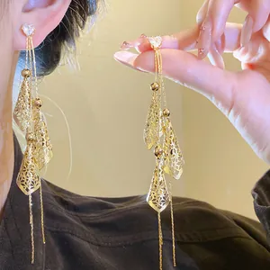 Close-up of elegant 18K gold plated long tassel earrings with sparkling heart zircons