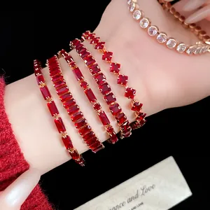 Close-up of luxury red square zircon tennis bracelets stacked on a woman's wrist