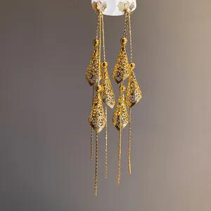 Close-up of 18K gold plated long tassel earrings with heart-shaped zircon studs