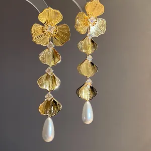Detailed view of elegant 18K gold plated flower earrings with zircons and drop pearls