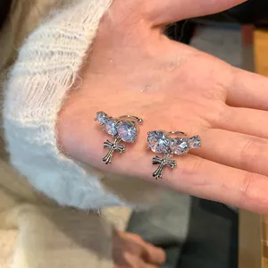 Detailed view of silver cross ear cuffs with sparkling round zircons for non-pierced ears