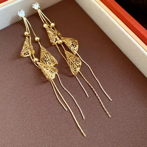 Close-up of elegant 18K gold plated tassel earrings with sparkling zircon studs detail