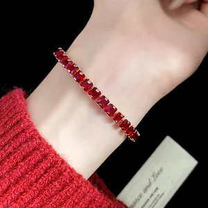 Detailed view of elegant vintage red square zircon tennis bracelet on female wrist