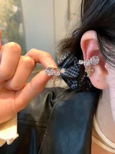Detailed view of silver cubic zirconia ear cuff with cross charm for non-pierced ears.