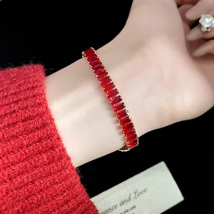 Macro view of a vintage gold bracelet featuring elegant square red zircon gemstones