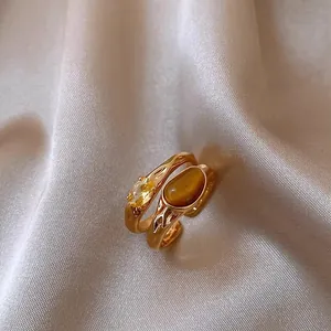 Macro detail of high-quality vintage gold-plated ring with zircon and tiger eye stones