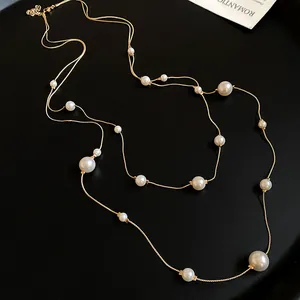 Macro view of French vintage double-layer necklace featuring asymmetrical white pearls.