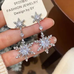 Exquisite macro view of sparkling zircon snowflake dangle earrings with S925 silver needle.
