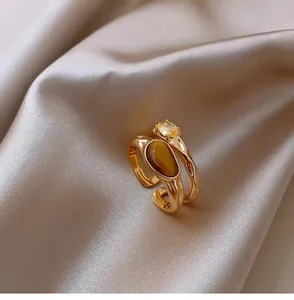 Detailed macro view of vintage gold-plated double-layer ring with tiger eye stone.
