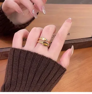 Close-up of vintage gold-plated double-layer ring with faux tiger eye stone and zircon