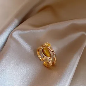 Macro view of vintage gold plated double layer ring with tiger's eye and zircon stones