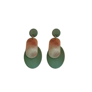 Fashionable acrylic earrings with dark green oval drops and pink marble textured disks.
