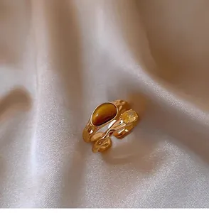 Close-up of vintage gold-plated double-layer ring featuring a faux tiger eye stone