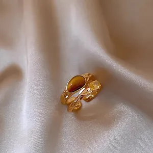Detailed view of gold-plated double-layer ring with synthetic tiger eye and zircon.
