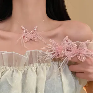 Detailansicht einer eleganten rosa Kristall Schmetterlingskette mit zarten Federn