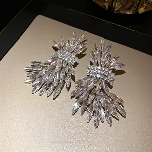 Luxury statement silver needle stud earrings featuring an intricate sparkling crystal wing design