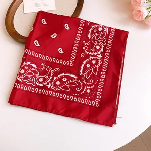 Detail shot of a red bandana with white paisley patterns on a decorative table.