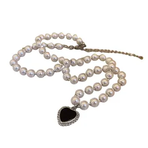 Elegant French vintage grey pearl necklace featuring a classic black heart charm pendant