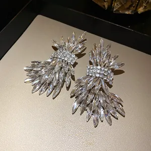 Exquisite close-up of sparkling crystal wing stud earrings on a luxury jewelry tray