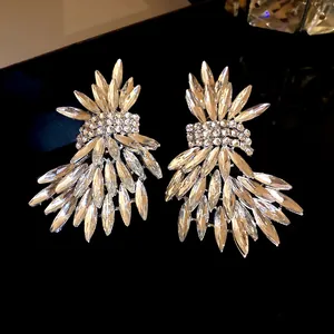Detailed view of silver needle crystal wing earrings with dazzling marquise rhinestones