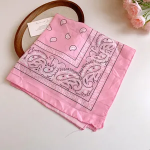 Detailed macro view of pink paisley sunflower pattern on soft lightweight fashion headscarf