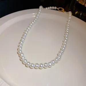 Detailed view of elegant white pearl necklace on a ceramic display plate