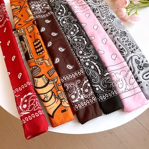 Detail view of colorful paisley and cowboy theme printed headscarves for fashion.