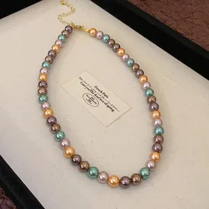 Elegant close-up of a vintage French style multi-colored pearl necklace in a display tray
