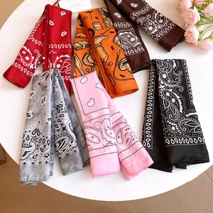 Close-up detail of colorful paisley and illustrated pattern silk-like headscarves