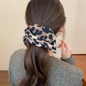 Vista dettagliata di un elastico per capelli leopardato marrone retrò sulla coda di cavallo