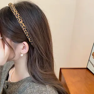 Vista dettagliata di un cerchietto leopardato retrò indossato da una modella in un interno