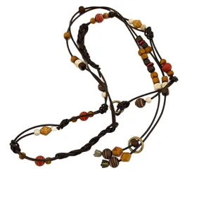 Bohemian leather waist chain with multi-colored irregular wooden beads and metal rings.