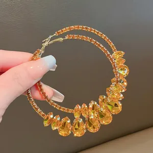 Elegant oversized hoop earrings with amber teardrop crystals and sparkling rhinestones.