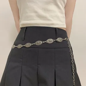 Detailed shot of Bohemian ethnic style silver metal waist chain on a black skirt