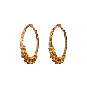 Vintage style rose gold hoop earrings with yellow teardrop crystals on white background