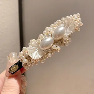 Vintage style pearl and petal duckbill hair clip with elegant handmade gold tag