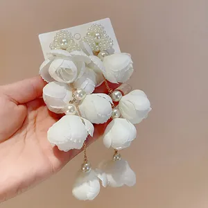 Elegant white fabric flower and pearl tassel earrings with gold chain detail for women