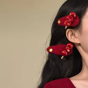 Detail shot of festive red flocked hair clips featuring traditional sugar-haws design