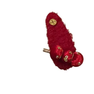 Elegant red flocked hair clip featuring festive tanghulu and golden copper coin design