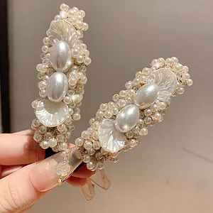 Detailed view of elegant pearl and petal hair clip set with golden accents for women.