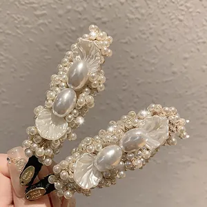 Close-up detail shot of pearl and petal hair clips with elegant vintage style craftsmanship.